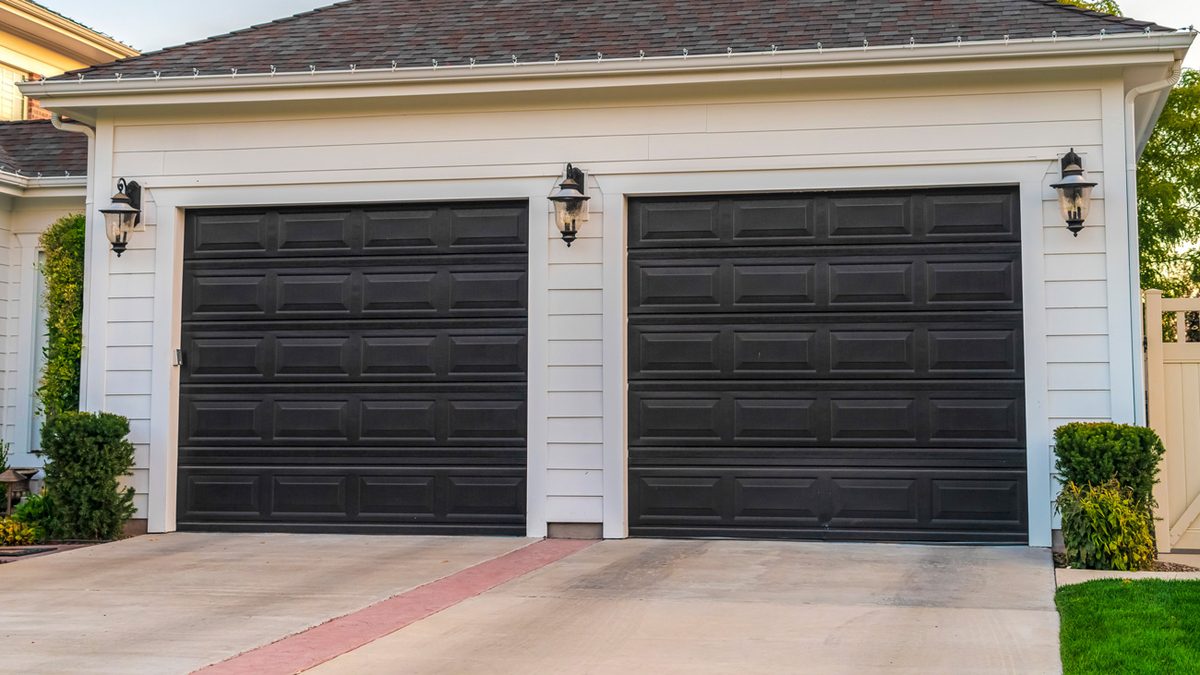 Modern black garage doors installed in Connellsville, PA by Bear Door Services