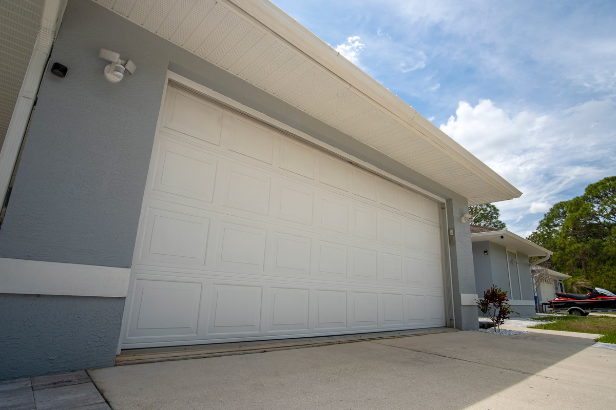 New CHI garage door installed on a brick home along the National Road in Brownsville, PA by Bear Door Services