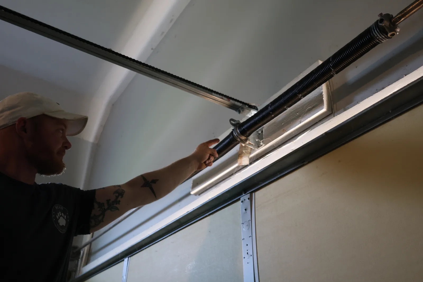 Bear Door Services technician performing routine garage door maintenance in Uniontown