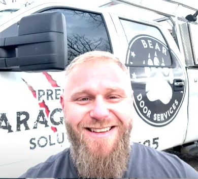 Michael, owner of Bear Door Services, in front of the company service truck